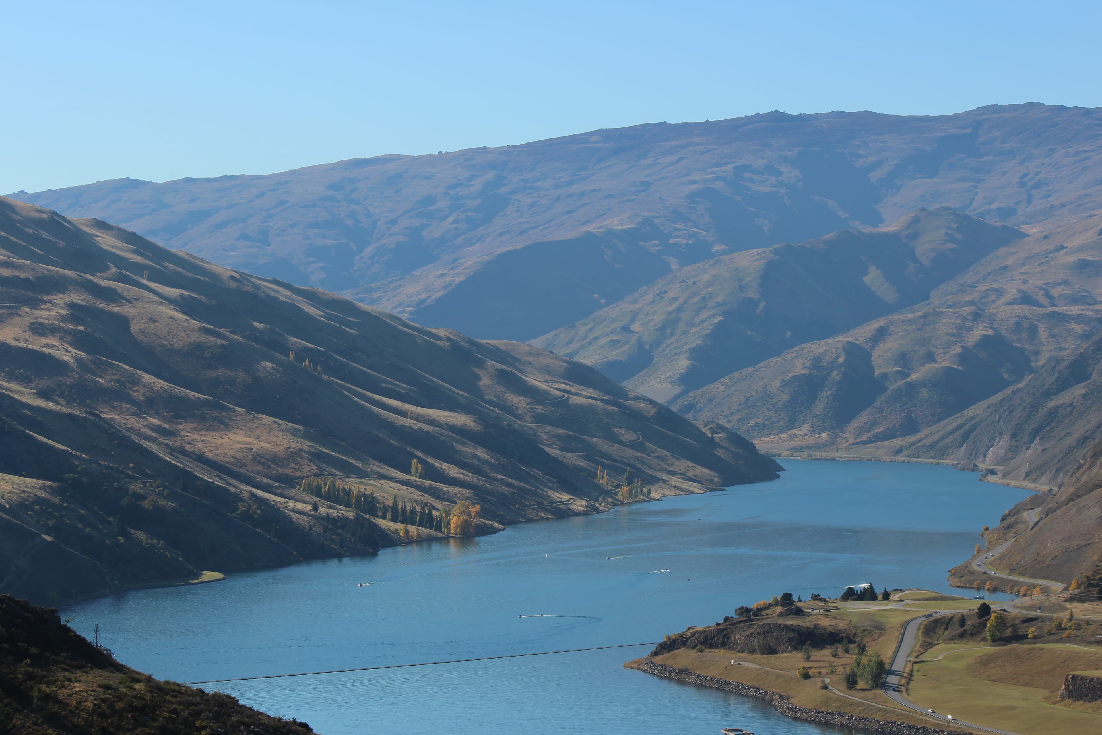 Lake gorge with boats on the water, Central Otago